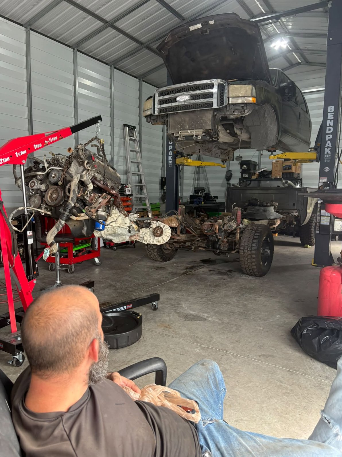 Truck lifted on the four-post lift during an engine job