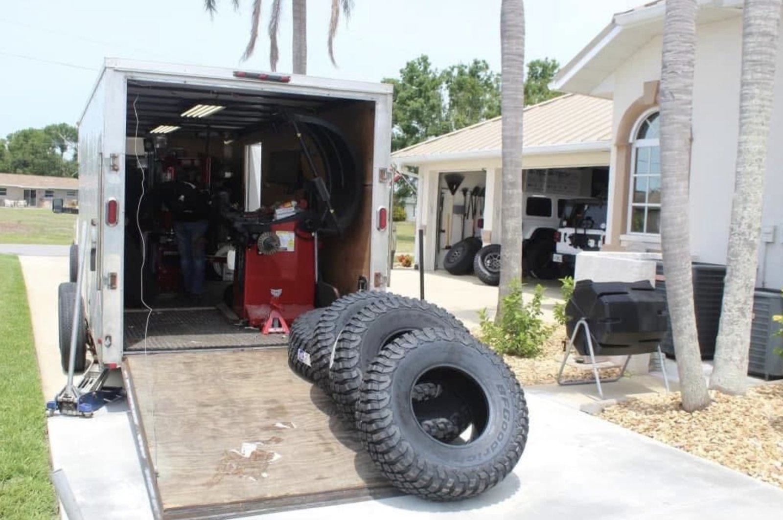 Fully equipped mobile service trailer with tire mounting machine and off-road tires